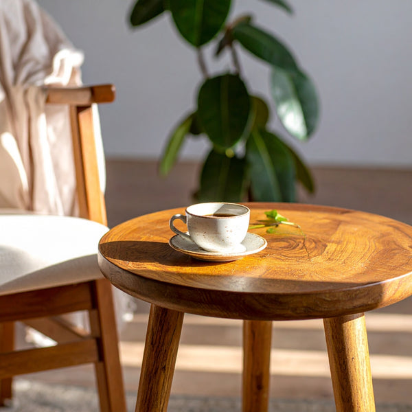 Wooden table with a cup and saucer on a blurred indoor background